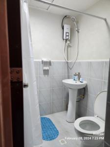 a bathroom with a shower and a toilet and a sink at Condo Mactan in Lapu Lapu City
