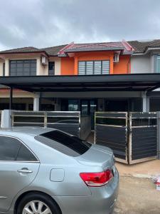 a car parked in front of a house at LW homestay Bukit Setongkol near Menara 188, HTAA in Kuantan