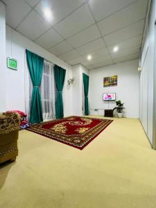 a living room with a rug on the floor at Homestay Seri Lanchang No16 in Kangar