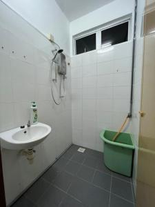 a bathroom with a sink and a shower at Homestay Seri Lanchang No16 in Kangar