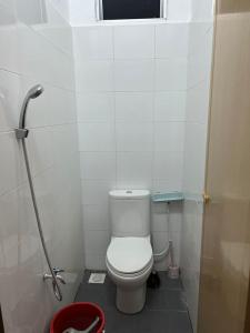 a small bathroom with a toilet and a window at Homestay Seri Lanchang No16 in Kangar