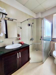 a bathroom with a sink and a glass shower at Ngọc Phương Anh Homestay Huế in Hue