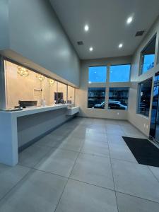 a large empty room with a counter and windows at Hotel del SOL in Corona