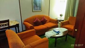 a living room with orange furniture and a table at Fantastic appartment at times square Kuala Lumpur in Kuala Lumpur