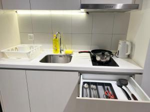 a small kitchen with a sink and a stove at Chambers suites in Kuala Lumpur