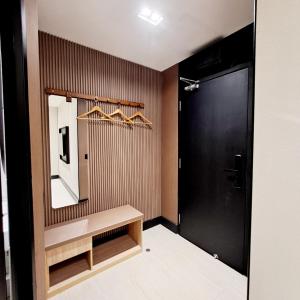 a bathroom with a mirror and a black door at Urban Inn, Salak Tinggi in Sepang