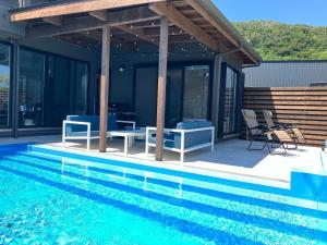 a house with a swimming pool and a pavilion at Retreat Villa Aym - Vacation STAY 18153v in Minamiboso