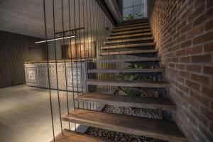 a staircase in a building with a brick wall at Ella Heritage in Ella