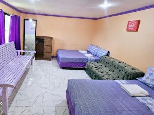 a hotel room with a bed and a couch at Einel Homestay 1 in Siquijor