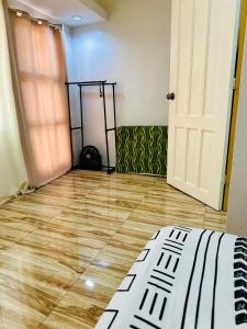 a room with a wooden floor and a door at La Maison - Homestay near Clark Airport in Angeles