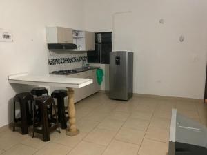 a kitchen with a counter and a refrigerator at Balcones de la Casona in Guatapé