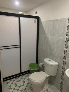 a bathroom with a toilet and a sink at Balcones de la Casona in Guatapé