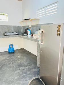 a kitchen with a refrigerator and a counter top at Medawatta Villa in Mirissa +87 photos