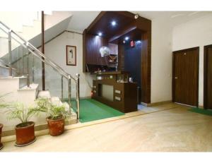 a living room with a staircase and a stair case at Hotel Shelton, Chandigarh in Chandīgarh