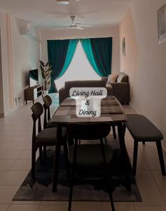 a dining room with a table and a couch at JC Homestay Gamuda SkyLuge KL 1 in Rawang