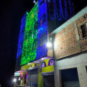 a building with blue and green lights on it at Hotel Durga Palace,Chapra in Chupra