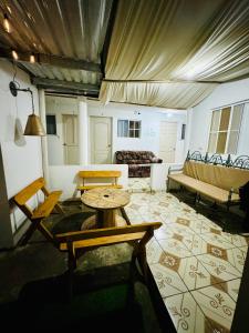 a living room with a couch and a table at Hostal Villa Marta in Santa Ana