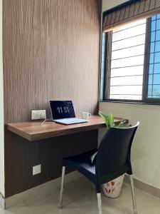 a desk with a laptop on it with a chair at Hotel Bramha Inn in Dāpuri