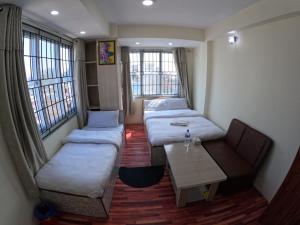 Voodi või voodid majutusasutuse Hotel Global Village toas
