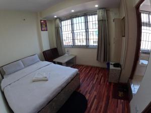 Voodi või voodid majutusasutuse Hotel Global Village toas