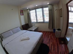 Voodi või voodid majutusasutuse Hotel Global Village toas