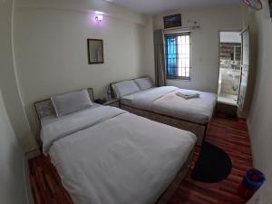 Voodi või voodid majutusasutuse Hotel Global Village toas