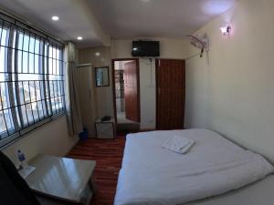 Voodi või voodid majutusasutuse Hotel Global Village toas