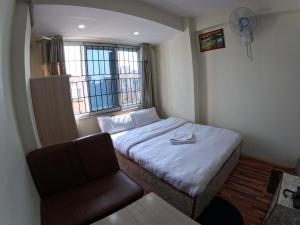 Voodi või voodid majutusasutuse Hotel Global Village toas