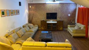 a living room with a couch and a television at VISTAHOMES in Hyderabad