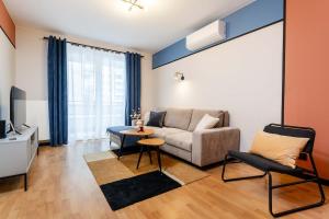 a living room with a couch and a table at Maple Tree Premium Apartment Mokotow in Warsaw