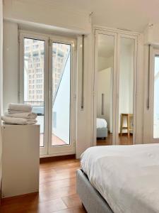 una camera con letto e porte scorrevoli in vetro di ComeCasa 2 bedrooms Larga apartment a Milano