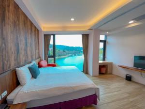 a bedroom with a bed and a large window at Zhaohong homestay in Yuchi