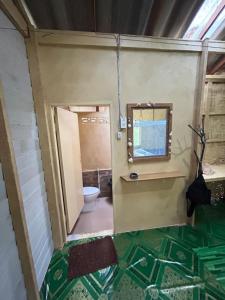 a bathroom with a toilet and a sink and a mirror at Sofee Homestay(Bulone Island),Thailand in Ko Bulon Le