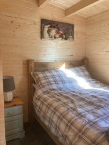 a bedroom with a bed in a log cabin at Captivating 1-Bed Lodge in Chesterfield in Chesterfield
