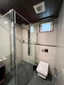 a bathroom with a shower and a toilet in it at HOTEL PRAJYOT in Pūrnia