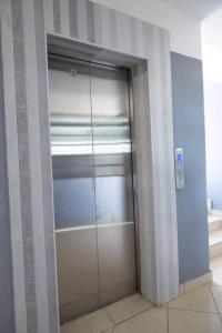 a glass door to a closet in a room at Kay homes in Nairobi