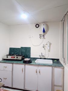 a kitchen with a sink and a counter top at Beechwood Holiday Apartments in Mussoorie