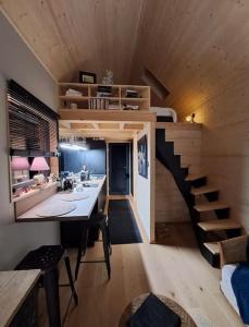 a room with a staircase and a room with a bed at LA MAISON UGOLIN Tiny House and INÈS in Baccarat +18 photos
