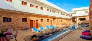 a house with a swimming pool with blue chairs at Carmine Hotel Dahab in Dahab