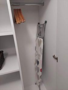 a door of a closet with a tie on it at ALDIRA Studio Arena Nationala in Bucharest
