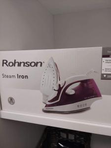 a iron is sitting on a shelf in a box at ALDIRA Studio Arena Nationala in Bucharest