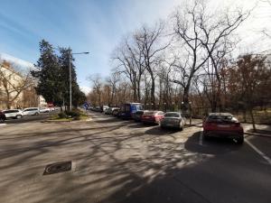 a street with cars parked in a parking lot at ALDIRA Studio Arena Nationala in Bucharest