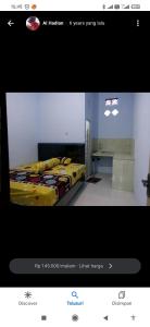 a picture of a bedroom with a bed in a room at Umah isun guests house in Banyuwangi