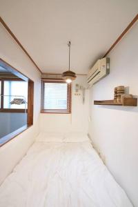 a room with a large bed with a window at Mapo Villa in Shinchon in Seoul