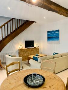 a living room with a couch and a table at Gite MCM in Chalais
