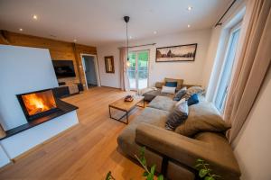 a living room with a couch and a fireplace at Ferienhaus Escherich in Büchlberg