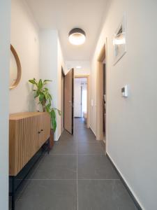 a hallway with a tile floor and a hallway with a plant at Trikala Leisure in Tríkala