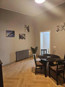 a living room with a dining room table and chairs at ZIG ZAG apartment 6 - Old Town Constanta in Constanţa
