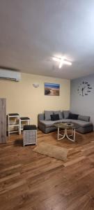 a living room with a couch and a table at Apartmaji Medved, brezplačno parkiranje in Tacen