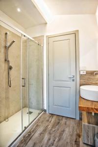 uma casa de banho com um chuveiro, um lavatório e uma porta em Villa Giuliana em Arezzo